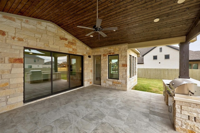 view of patio with an outdoor kitchen, ceiling fan, and grilling area