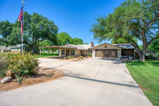 single story home with a garage, a carport, and a front lawn