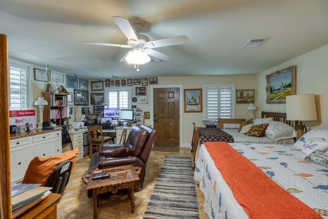 tiled bedroom featuring ceiling fan