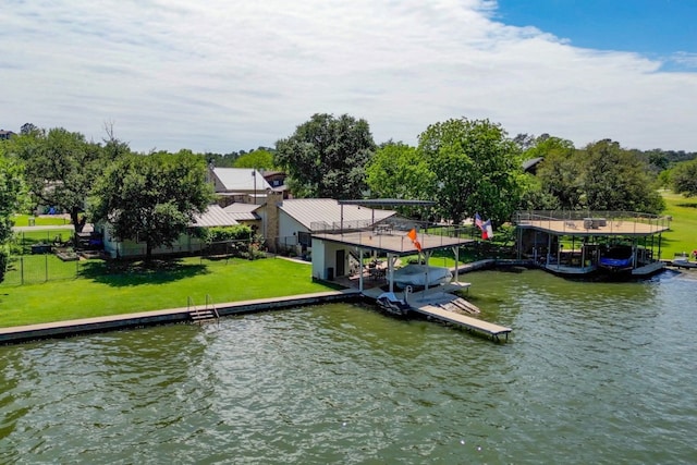 view of dock featuring a lawn and a water view