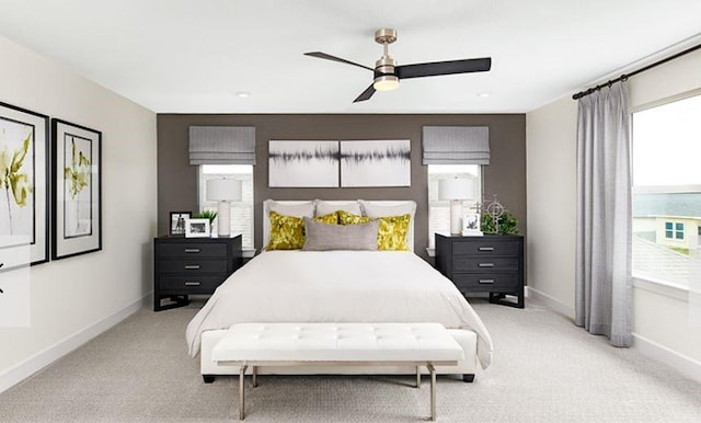 bedroom featuring light colored carpet, ceiling fan, and baseboards