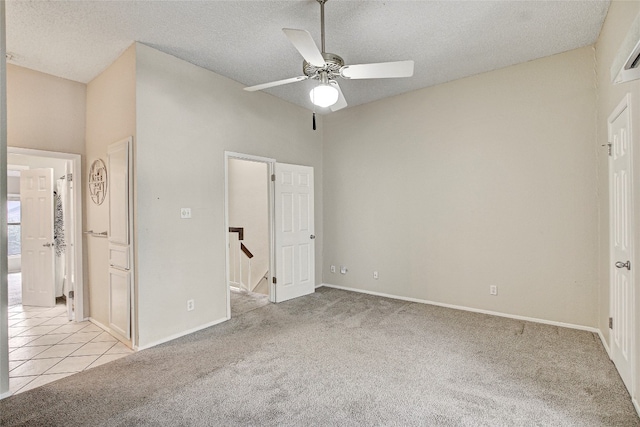 unfurnished bedroom featuring ceiling fan, high vaulted ceiling, light colored carpet, and a textured ceiling