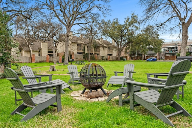 surrounding community with a yard and an outdoor fire pit