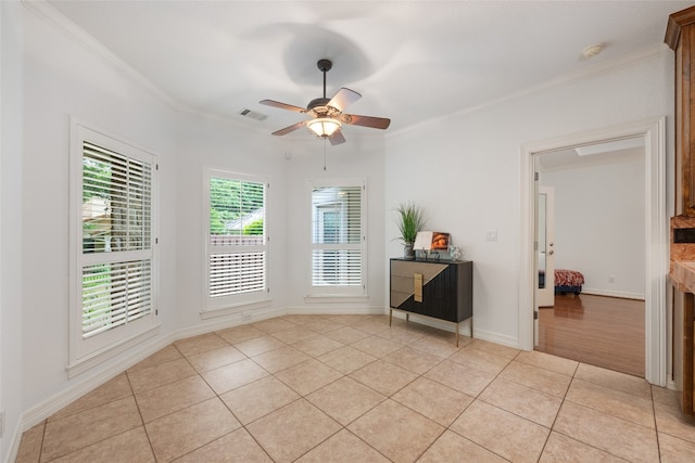 unfurnished room featuring ornamental molding, ceiling fan, and light tile floors