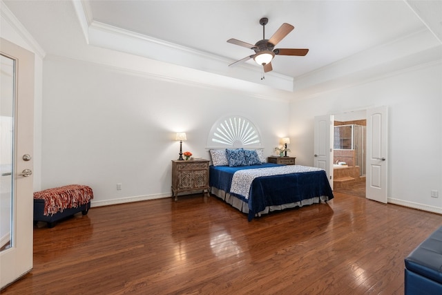 bedroom featuring ceiling fan, crown molding, dark hardwood / wood-style floors, a raised ceiling, and connected bathroom