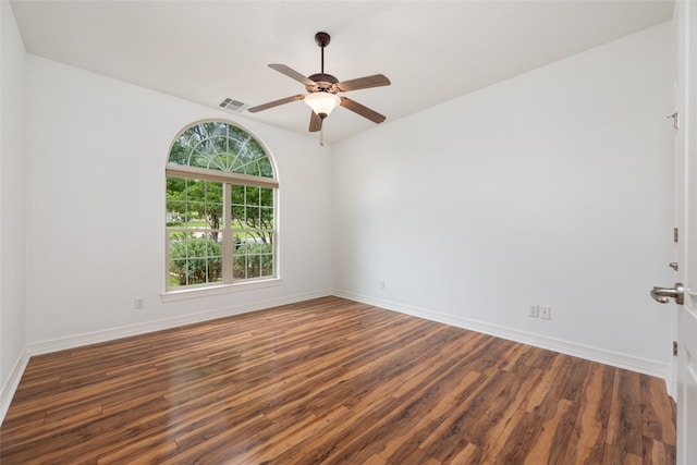 empty room featuring dark wood-type flooring and ceiling fan