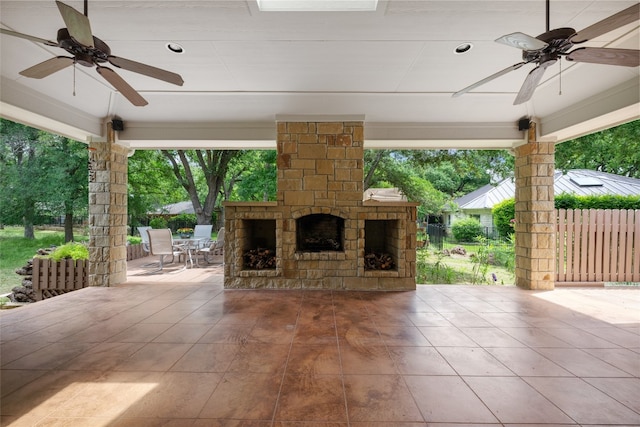 view of patio / terrace with an outdoor stone fireplace and ceiling fan