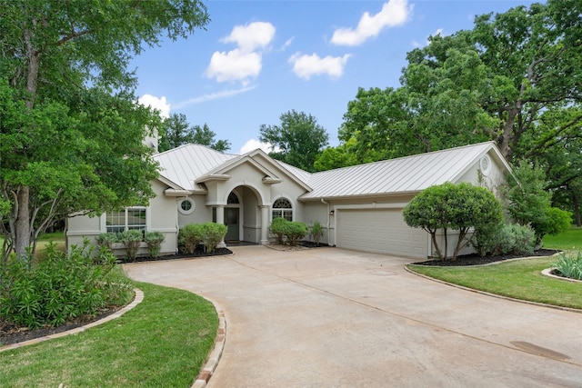 ranch-style house featuring a front yard and a garage