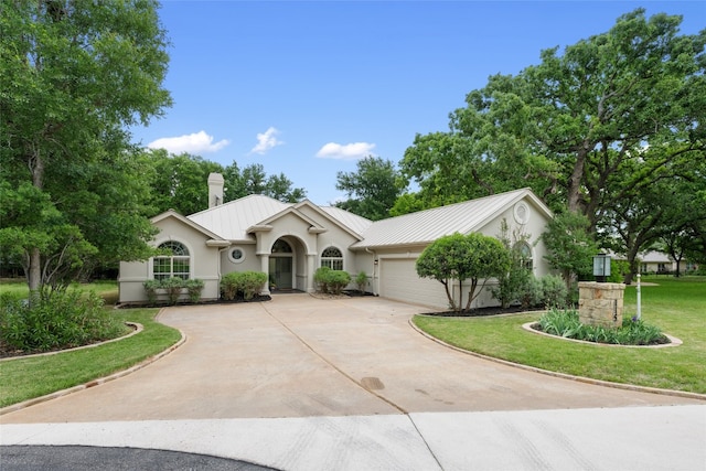 single story home featuring a front yard and a garage