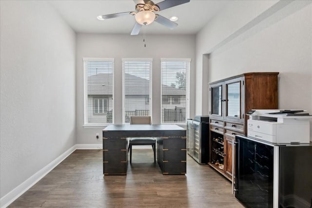 office space featuring wine cooler, dark wood-style flooring, ceiling fan, and baseboards