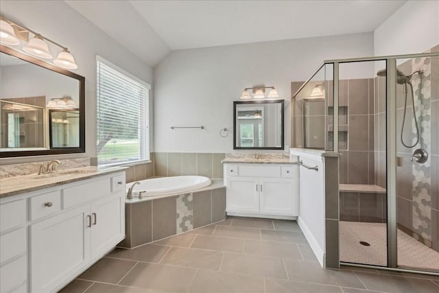 full bathroom with a garden tub, a sink, and a shower stall