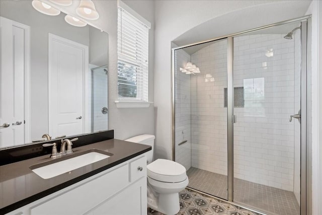 full bathroom with toilet, a shower stall, and vanity