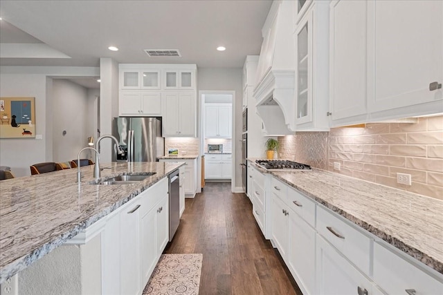 kitchen with visible vents, stainless steel appliances, glass insert cabinets, and white cabinets