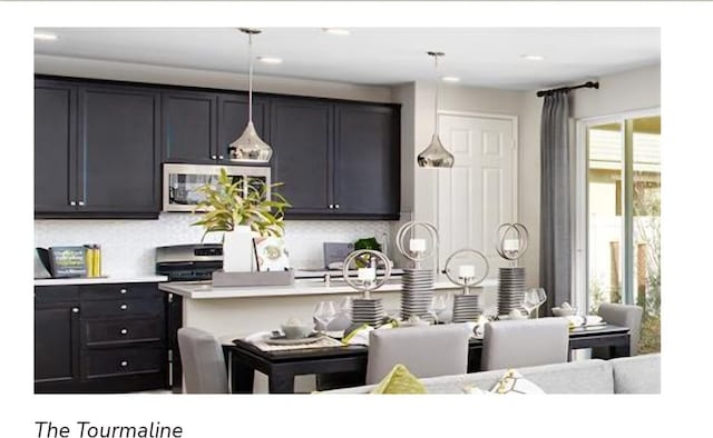 kitchen with decorative backsplash, pendant lighting, and a wealth of natural light