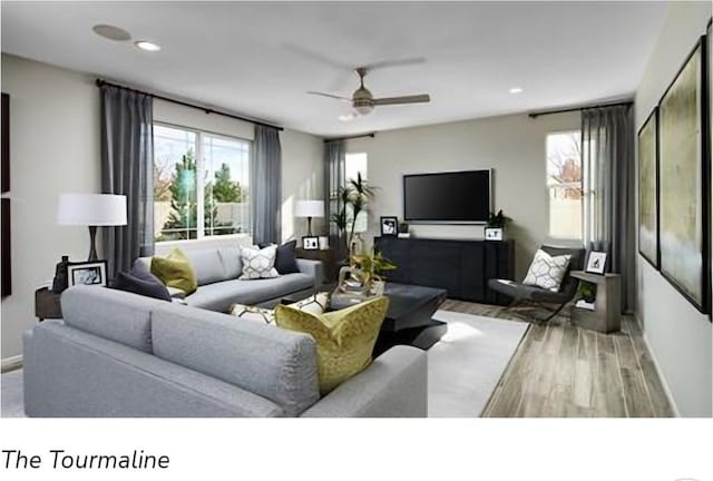 living room featuring ceiling fan and light hardwood / wood-style floors