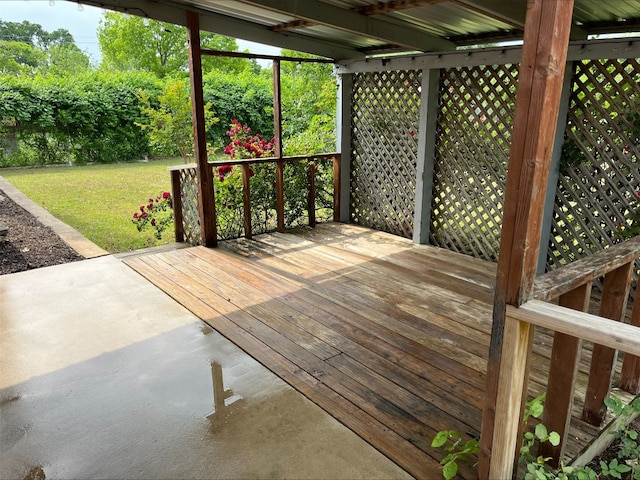 wooden terrace with a lawn