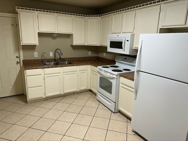 kitchen featuring light tile floors, white appliances, and sink