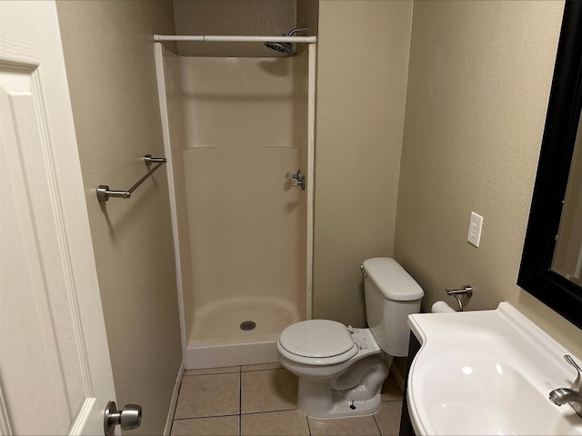 bathroom with a shower, sink, toilet, and tile flooring