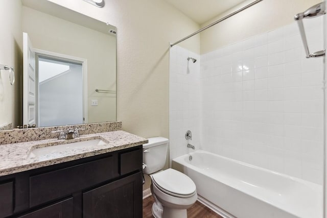 full bathroom with hardwood / wood-style flooring, bathing tub / shower combination, vanity, and toilet