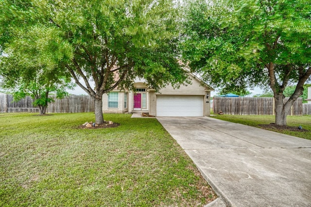 view of front of property featuring a garage and a front yard