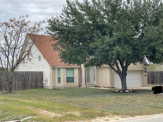 view of front of home with a garage and a front yard