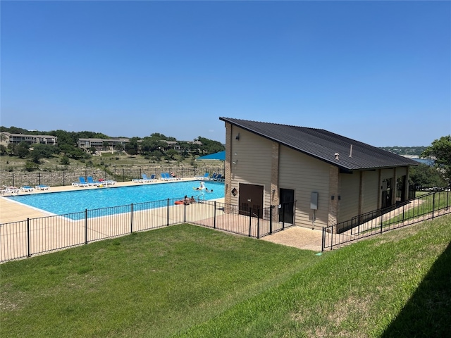 view of pool featuring a patio area and a yard