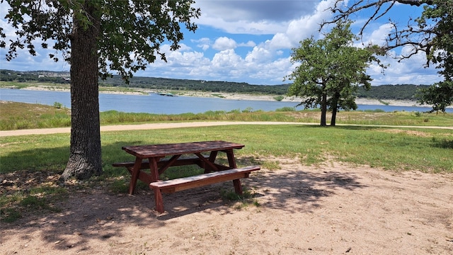 view of community with a water view and a yard