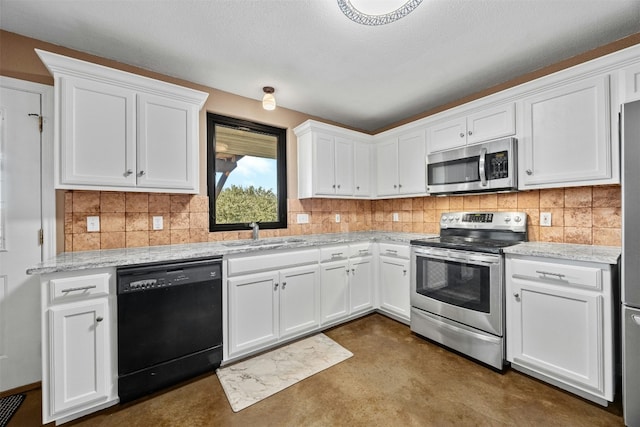 kitchen with appliances with stainless steel finishes, backsplash, light stone counters, sink, and white cabinets