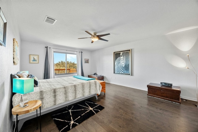 bedroom featuring a textured ceiling, ceiling fan, and dark wood-type flooring