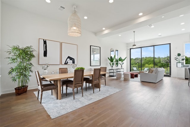 dining space with wood-type flooring and ceiling fan