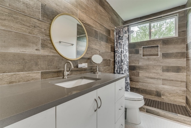 bathroom featuring tile walls, oversized vanity, toilet, tile floors, and walk in shower