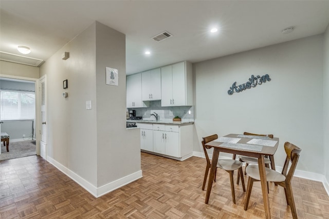 dining room featuring light parquet floors and sink