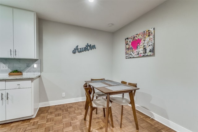 dining area featuring light parquet flooring