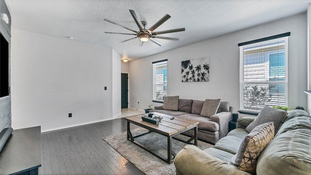 living room with hardwood / wood-style flooring, ceiling fan, and a textured ceiling