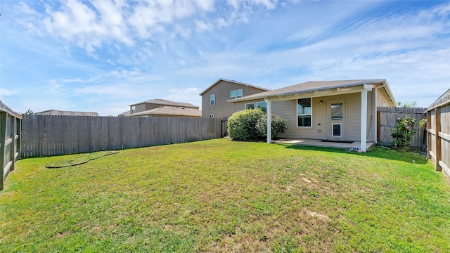 rear view of house with a patio area and a lawn