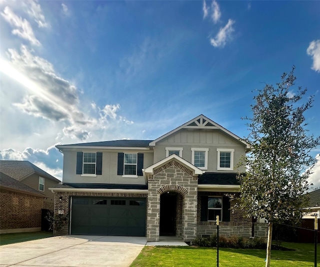 view of front of property with a garage and a front lawn