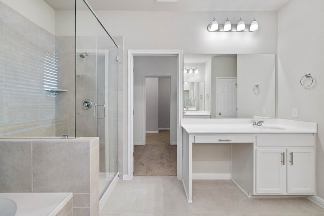 bathroom with vanity with extensive cabinet space, an enclosed shower, and tile floors