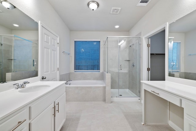 bathroom with shower with separate bathtub, tile floors, and oversized vanity