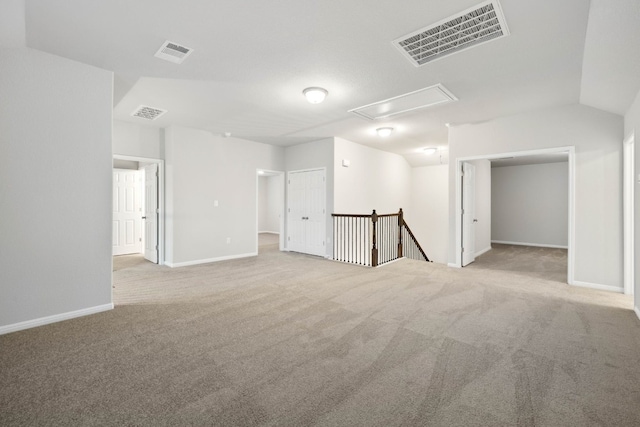 empty room featuring vaulted ceiling and carpet floors