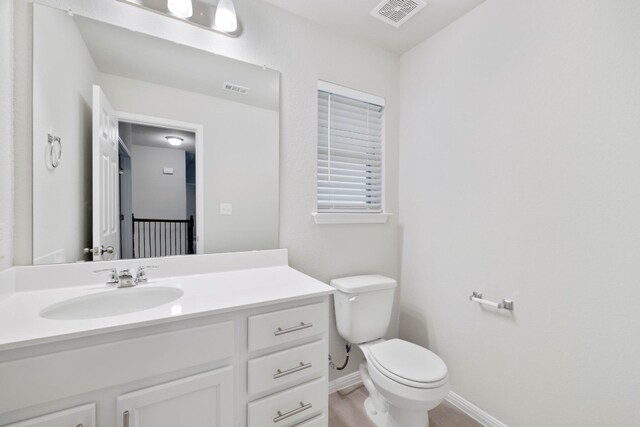 bathroom with oversized vanity and toilet