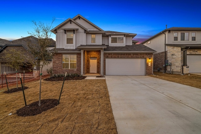 view of front of property with a garage and a yard