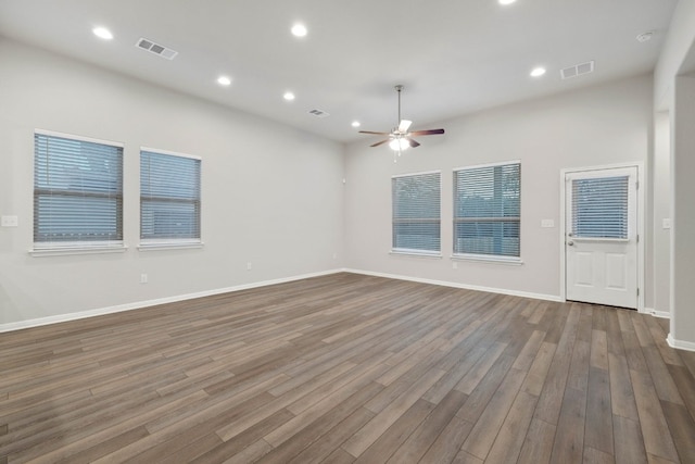 empty room with hardwood / wood-style flooring and ceiling fan