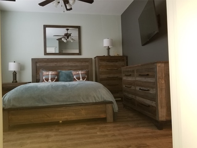 bedroom featuring wood-type flooring and ceiling fan