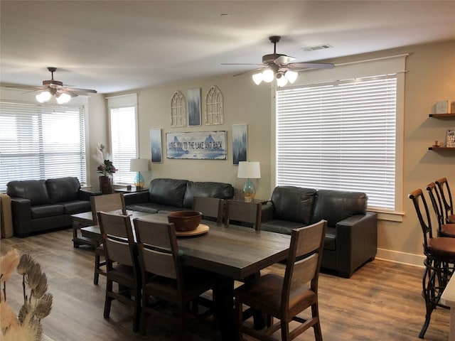 dining area with wood-type flooring and ceiling fan