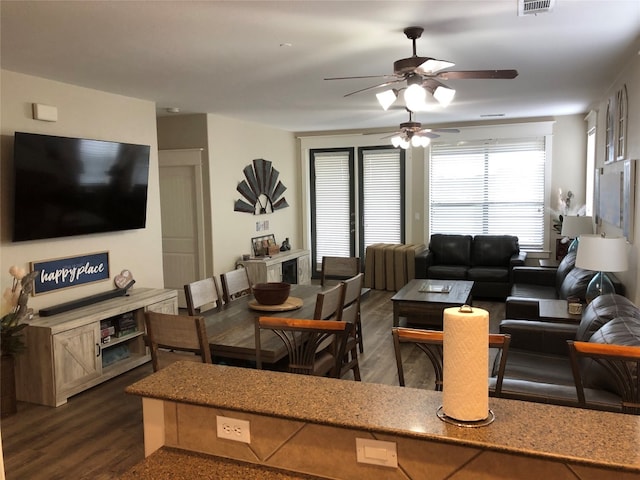 living room featuring dark hardwood / wood-style flooring and ceiling fan