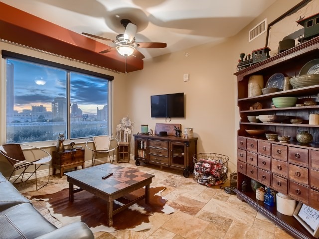 living room with ceiling fan and light tile floors