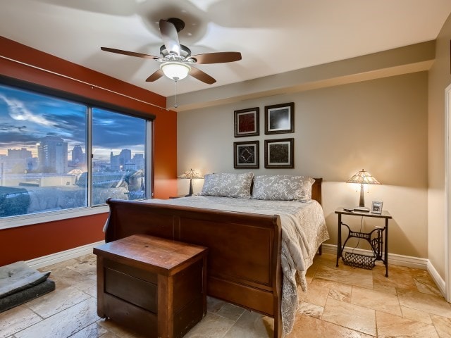 bedroom with ceiling fan and light tile floors