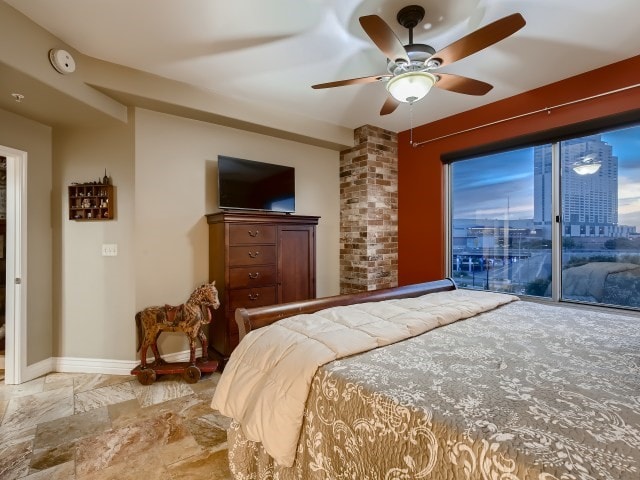 tiled bedroom featuring brick wall, ceiling fan, and access to outside