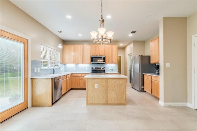 kitchen featuring backsplash, a kitchen island, pendant lighting, appliances with stainless steel finishes, and light brown cabinets