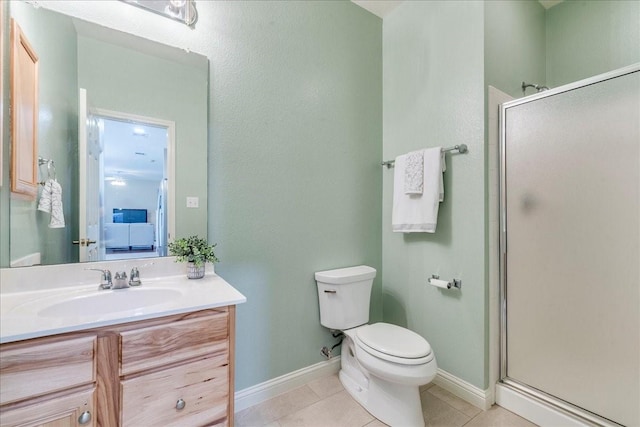 bathroom with vanity, toilet, tile patterned floors, and a shower with door